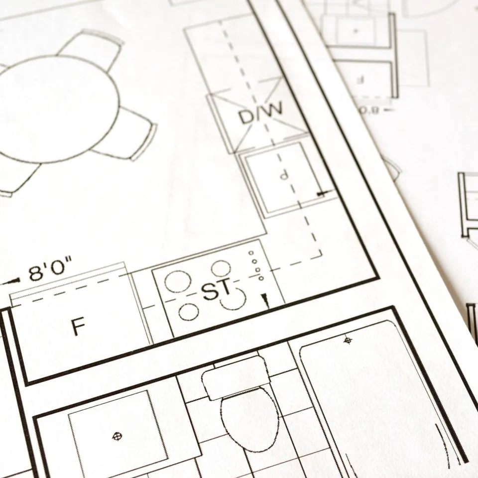 Close-up of printed floor plans showing furniture symbols and room measurements