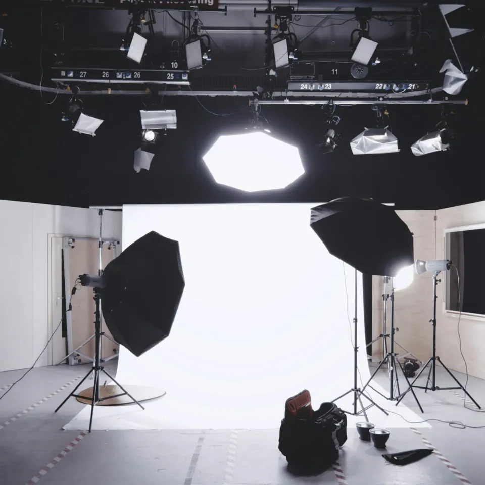 Photography studio with octabox and umbrella lights around a glowing white cyclorama backdrop